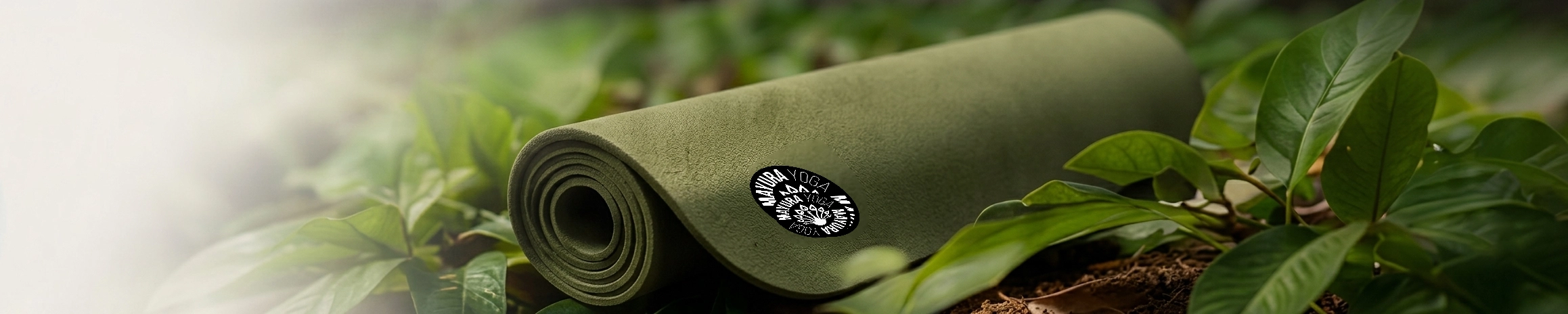 Rolled green natural rubber yoga mat